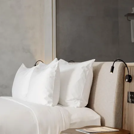 M Hotel Danang Exterior photo Pillows on a bed
