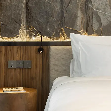 M Hotel Danang Exterior photo A bedside table with a built-in power socket